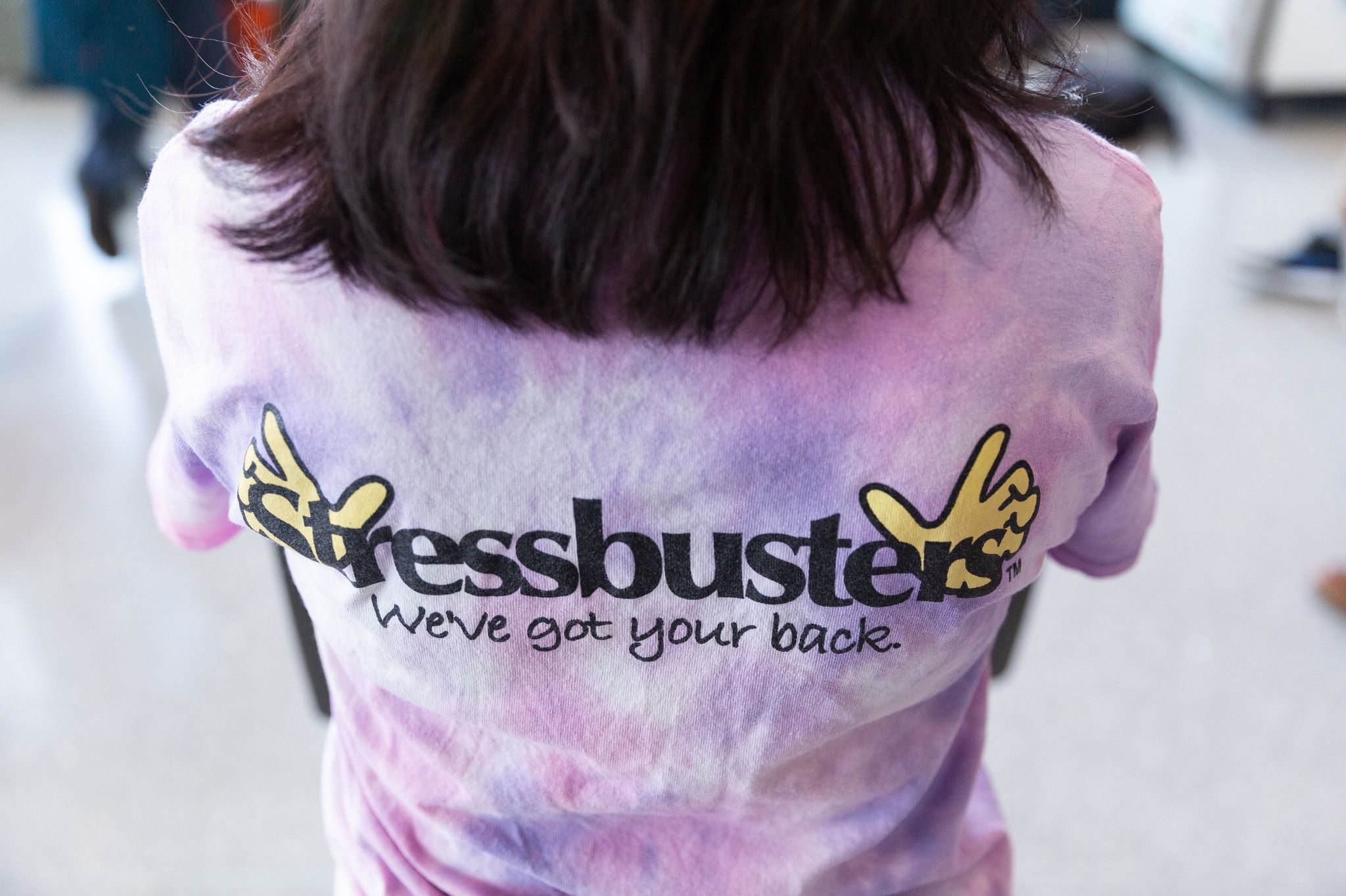 A student poses in a stressbusters t-shirt.