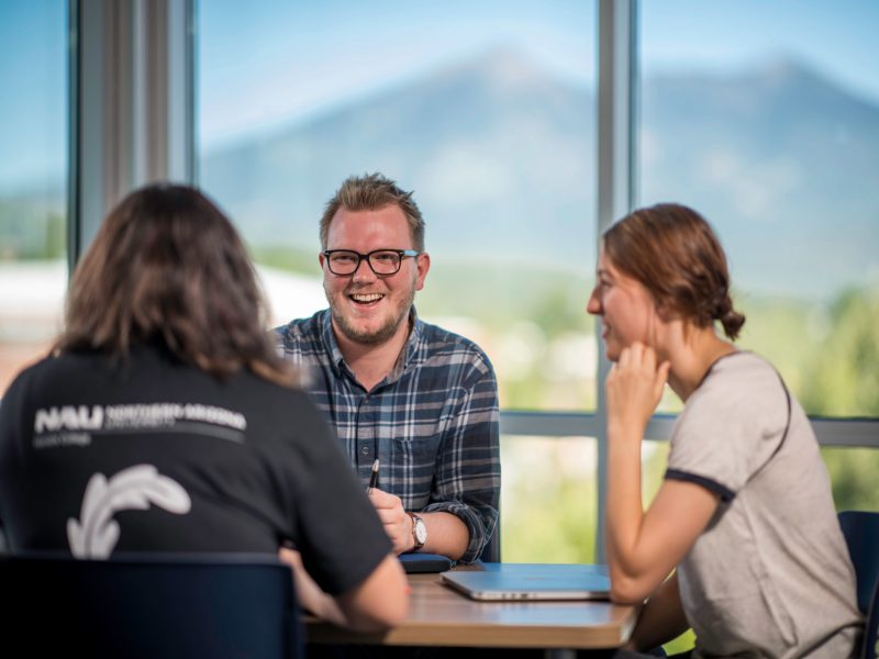 Students sitting around a table in discussion.