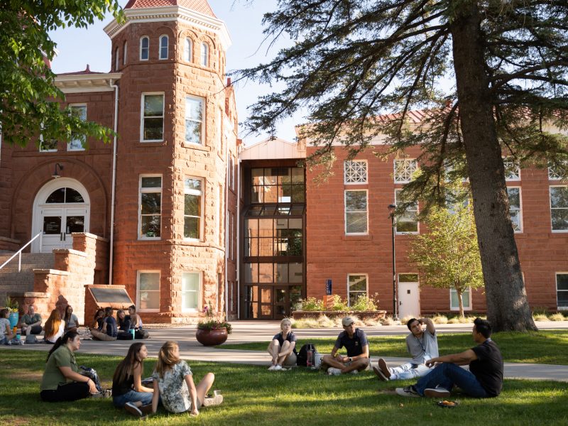 A group of students sitting in front of Old Main during Onboarding.