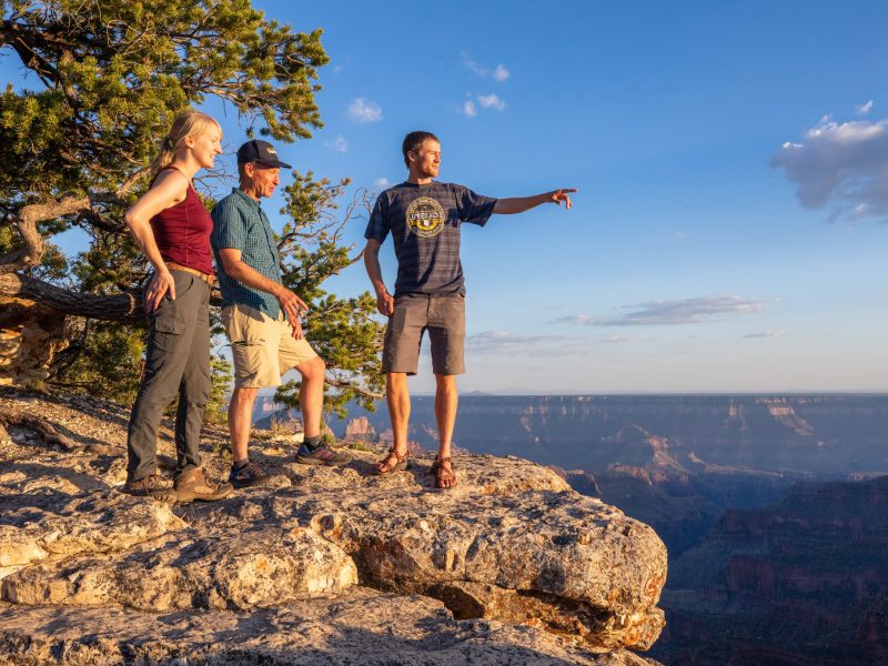 Professor and students standing next to a cliffside at the Grand Canyon.