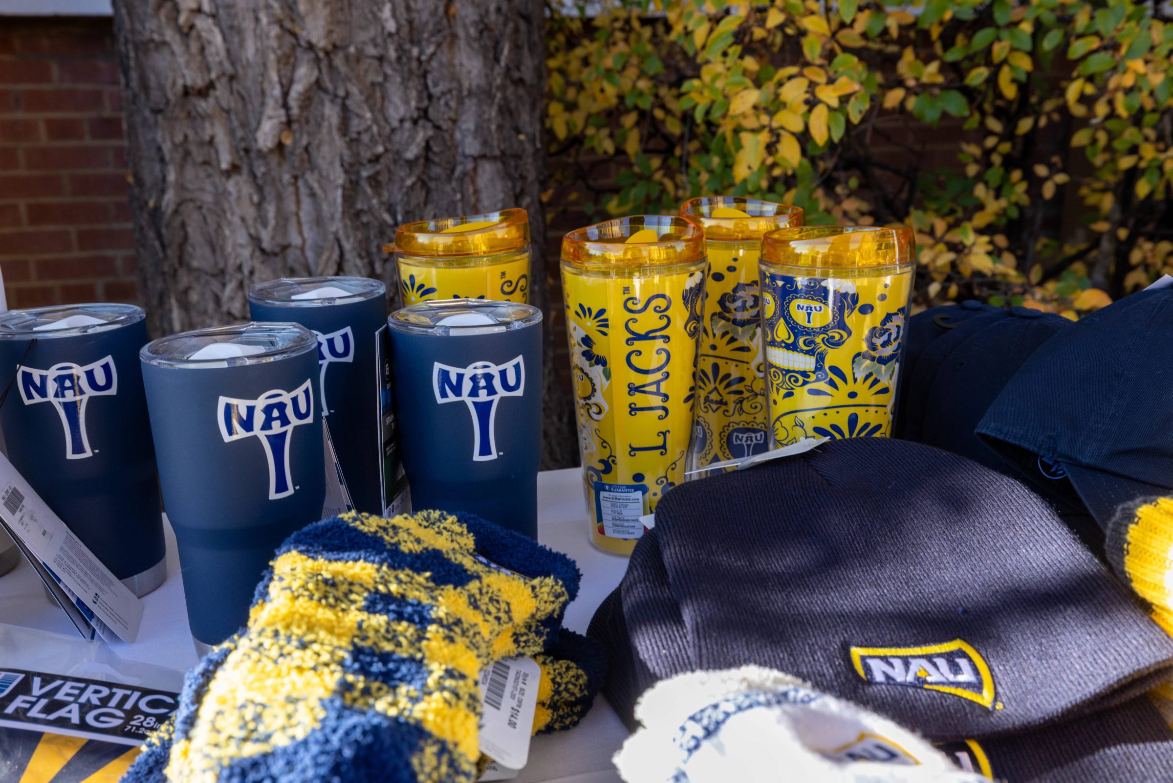Merchandise with various N A U logos and Lumberjack symbols.