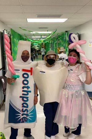 Three people wearing different costumes.