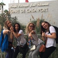 Four women pointing at the camera.