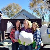 Three women holding a tooth pillow.