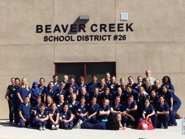 A group of dental hygienists wearing scrubs.
