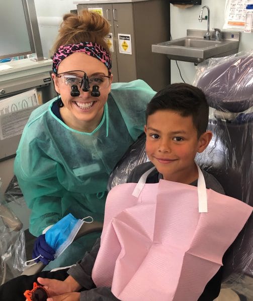 A dental hygientists with a kid.