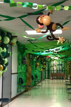 A decorated hallway with green streamers.