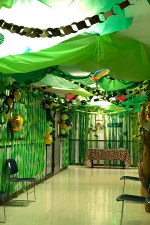 A decorated hallway with green streamers.