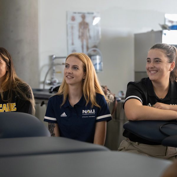 Select this image to learn more about scholarships. Athletic trainers sitting by.