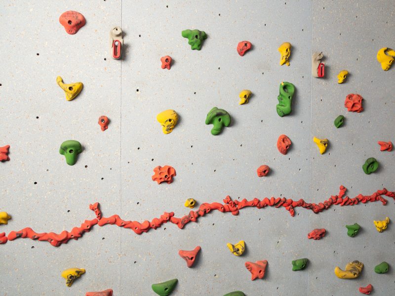 A picture of an indoor rock climbing wall.