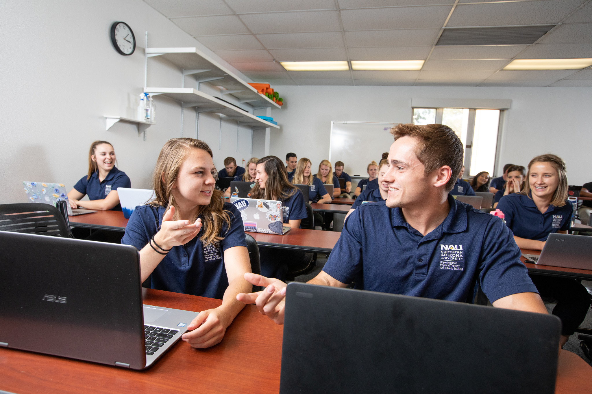 A class of students working on the computers.