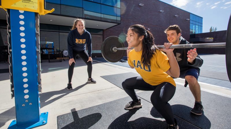 Student lifting weights.