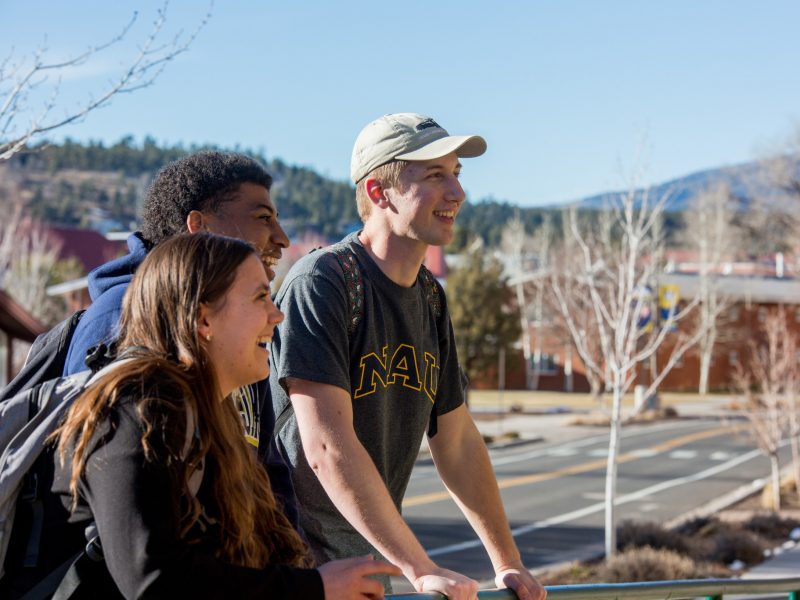 Students outside, smiling.