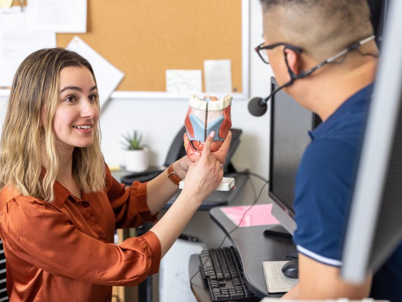 Lab student measuring a liquid.
