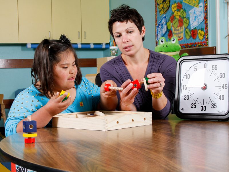 A teacher and a child playing a game.