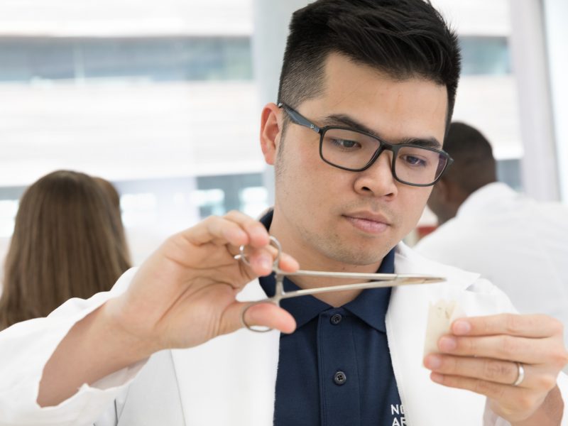 Physician assistant student prepares to practices giving stitches.