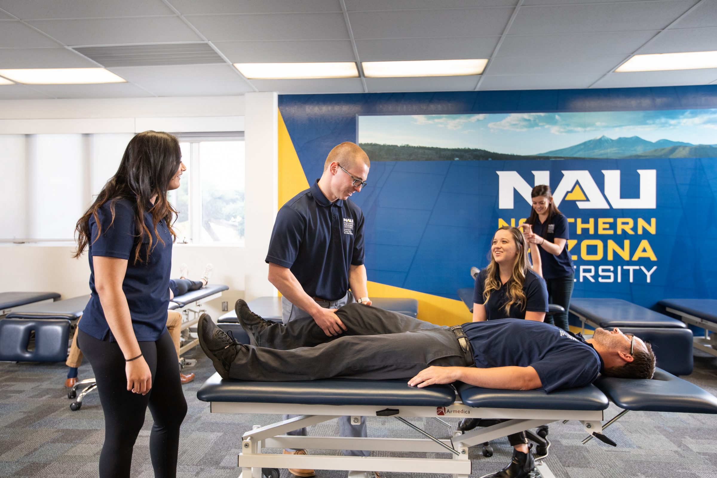 Physical therapy students working on a patient.