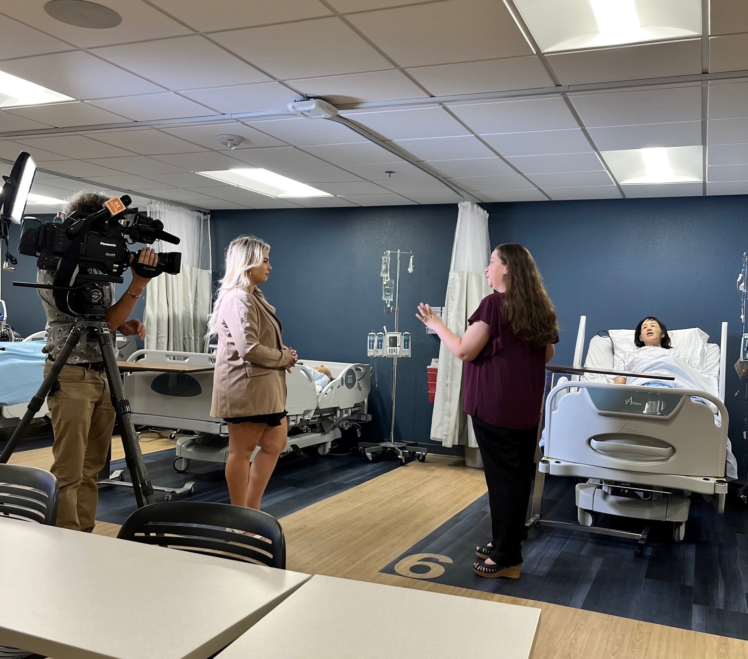 A news anchor interviews a N A U nursing teacher.