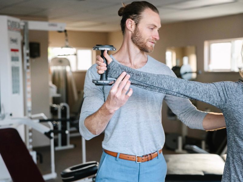 Physical Therapist and N A U alumni, Dustin Titcomb, working with a client.
