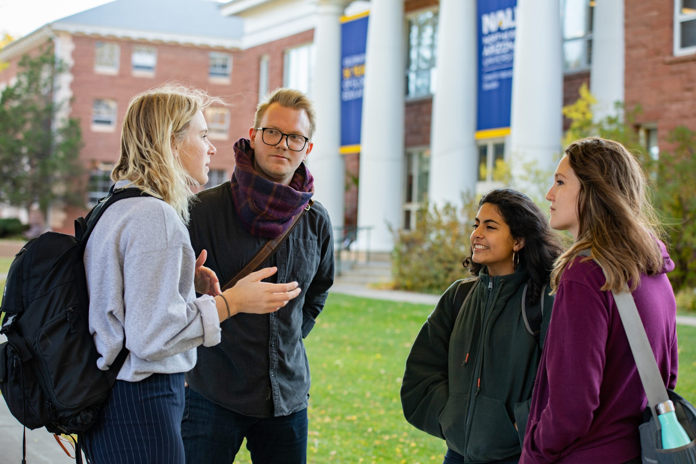 Students talking amongst each other outside on N A U Flagstaff campus.