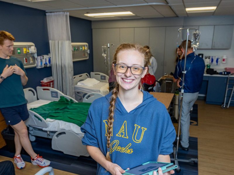 Sara Thomasson smiling with a doctor's office behind.