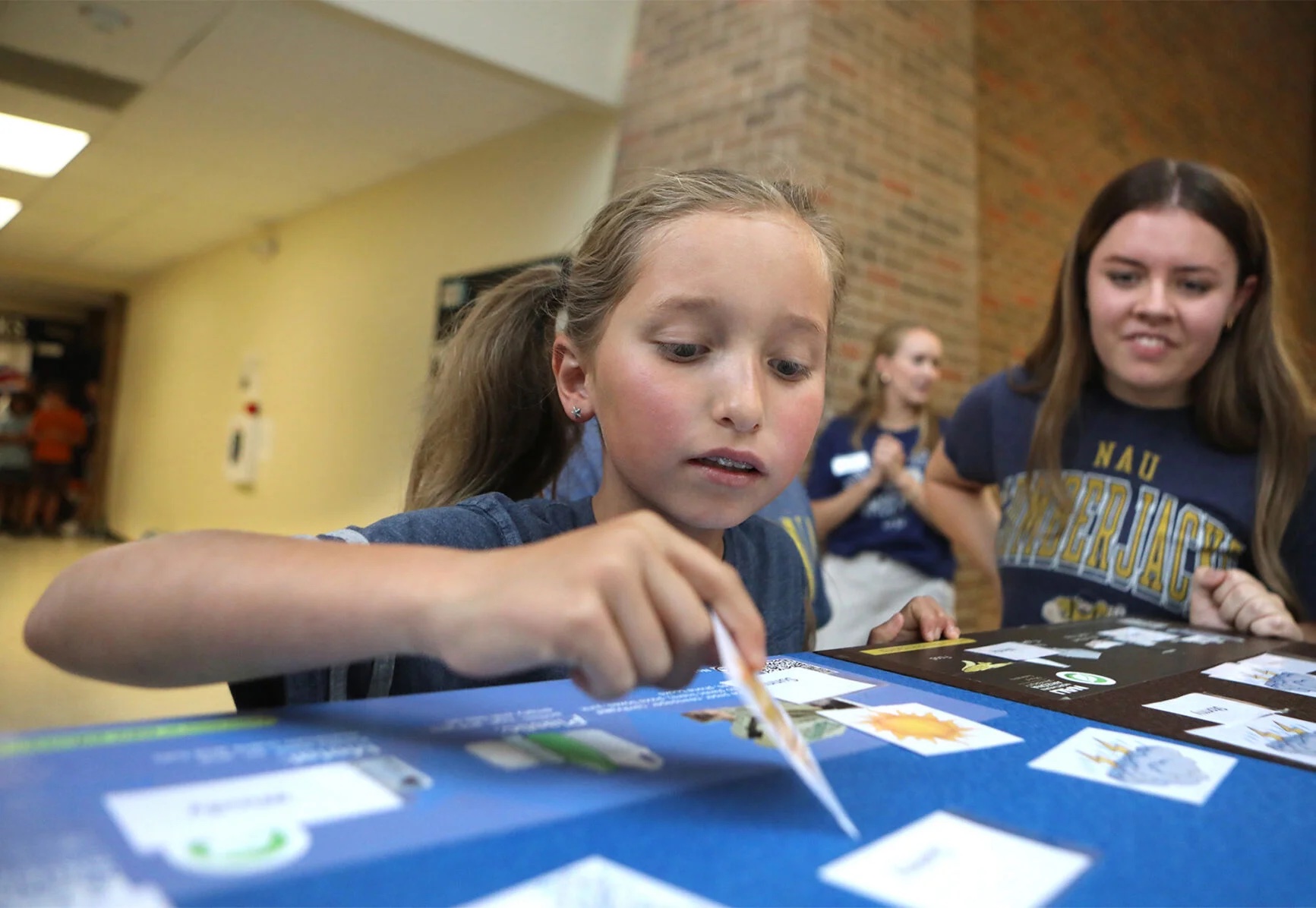 Evie Lewis, 10, looks to match words with pictures as part of a weather relay race during the Reading Between the Pines summer camp on Tuesday, July 1, at Northern Arizona University. The camp serves children with dyslexia and other reading challenges through fun activities and literacy therapy overseen by licensed speech-language pathologists.