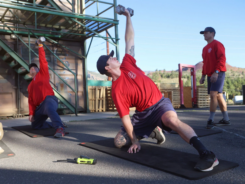 Tanor Loosle, Greater Flagstaff Region Fire Academy recruit, completes an exercise during an athletic training program session at the Flagstaff Fire Department training tower.