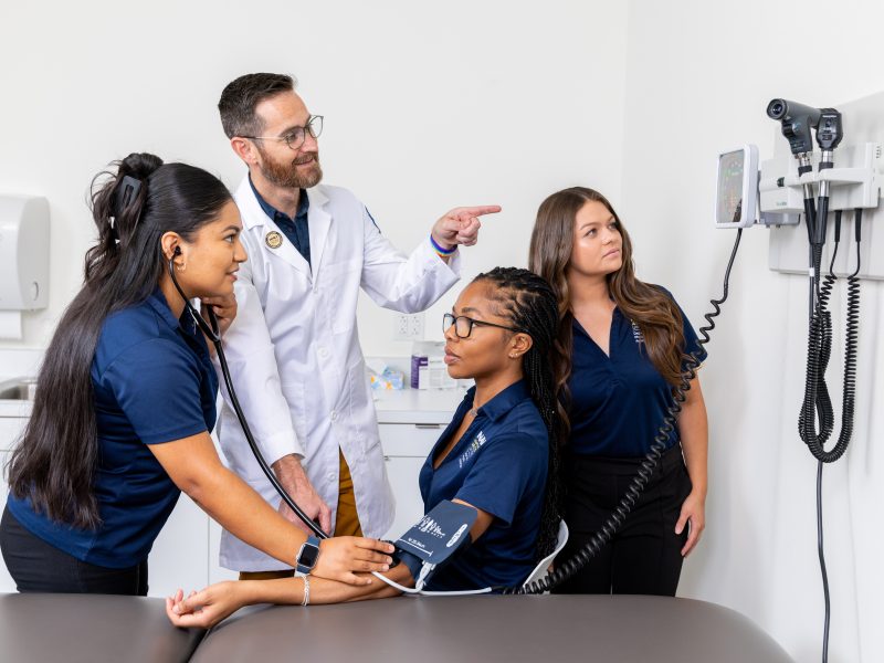 People in medical uniforms, doctor, and patients in a medical setting with medical equipment.