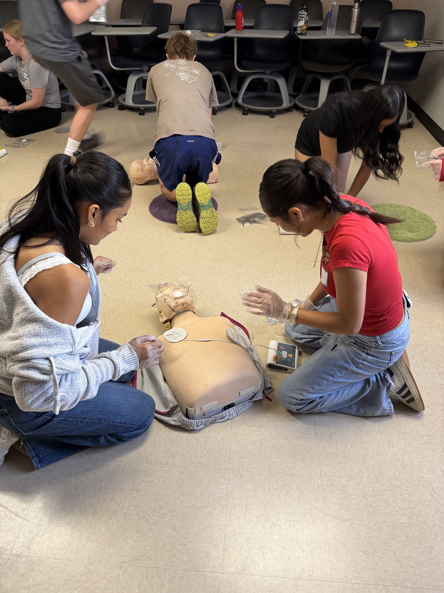 Students learn CPR on dummies.