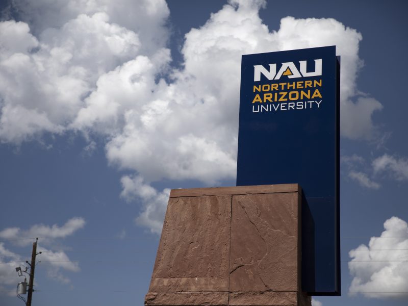 Large signage displaying the name "Northern Arizona University" against a blue sky with white clouds.