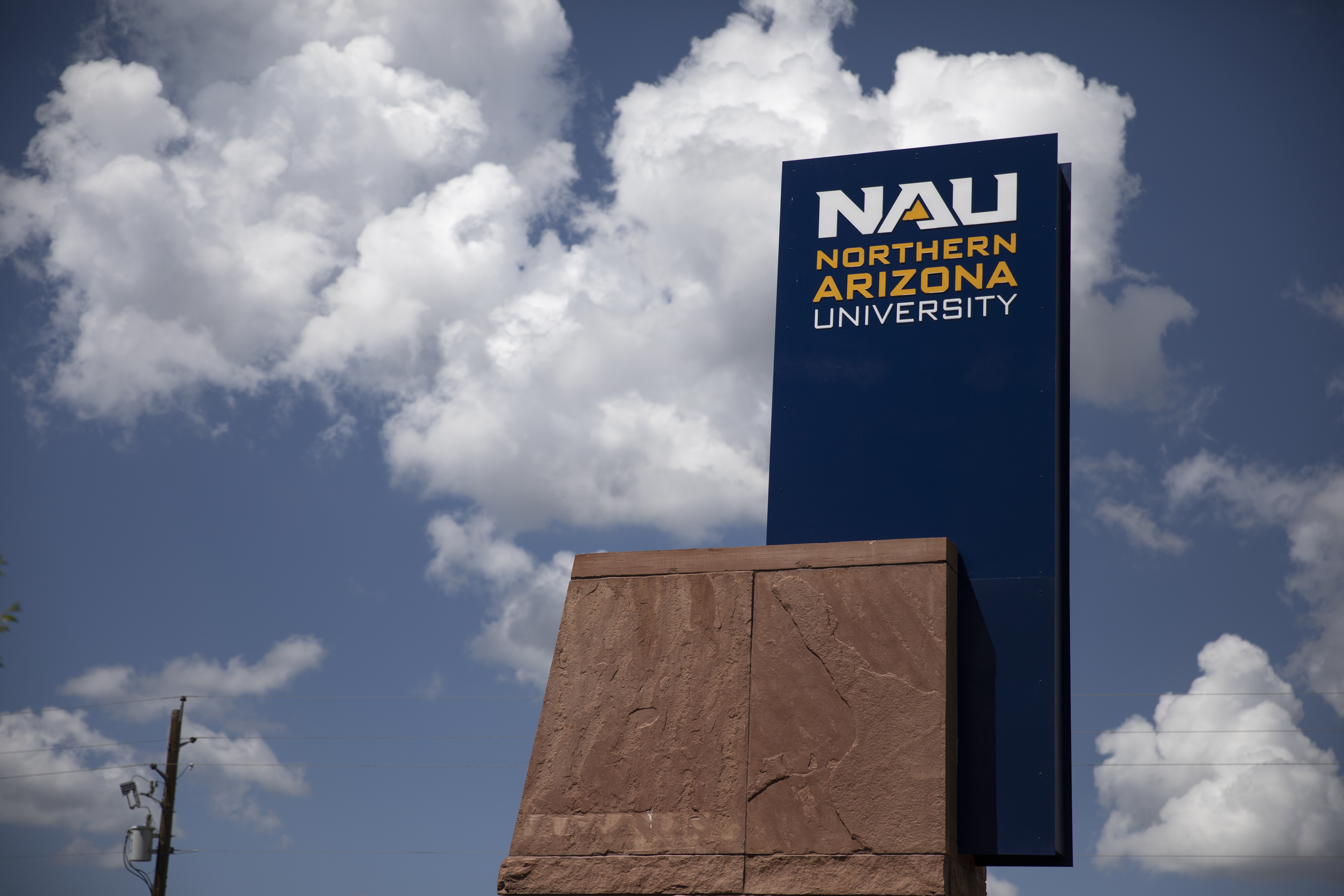 Large signage displaying the name "Northern Arizona University" against a blue sky with white clouds.