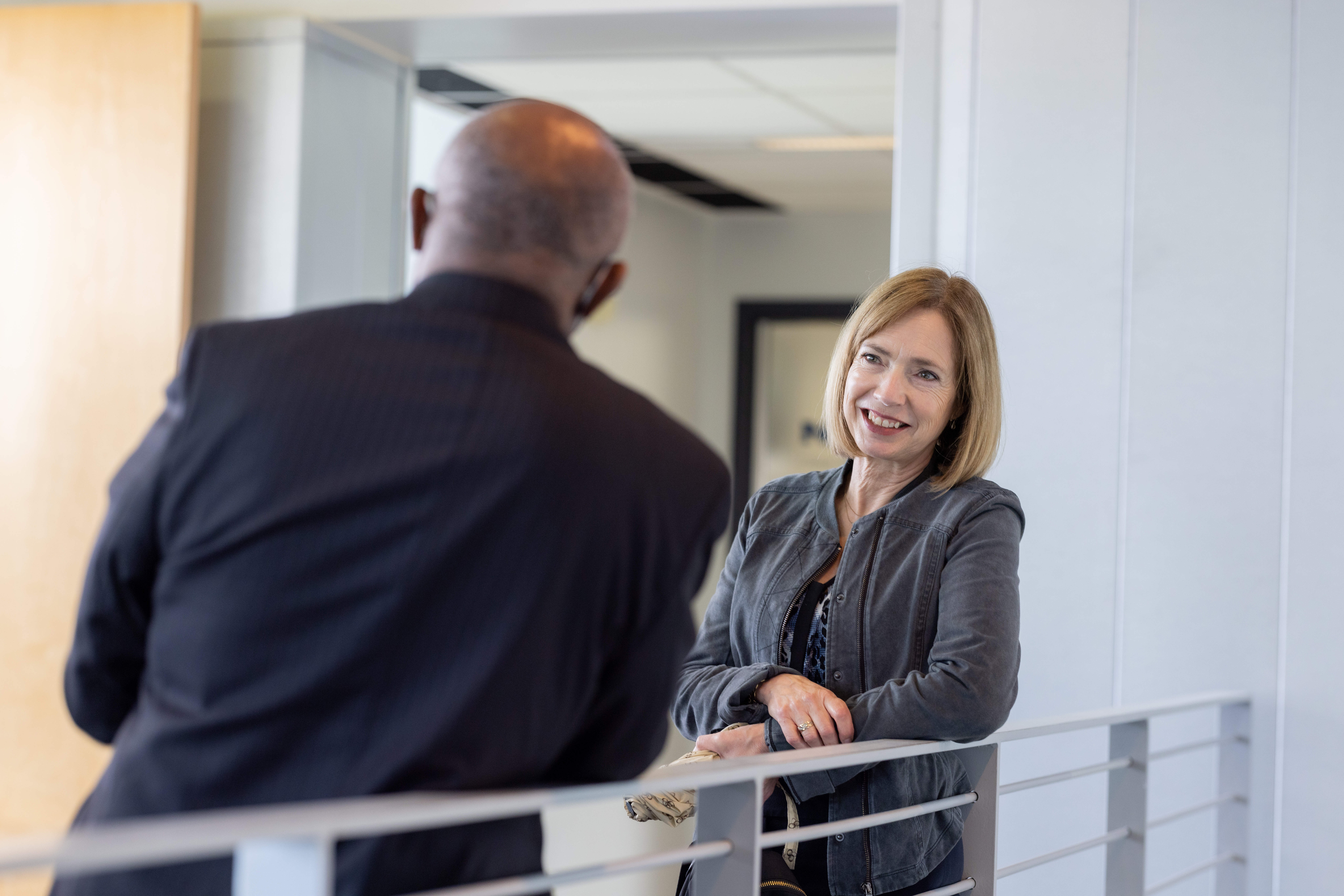 Alumni speaking in hallway.