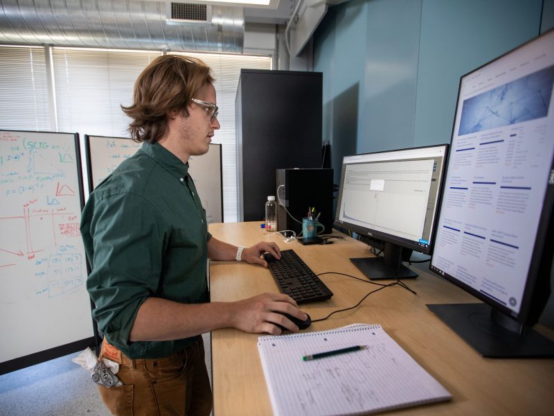 Ben ruddell working on a monitor.