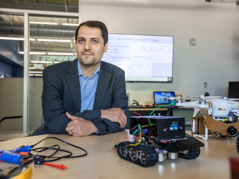 Faculty sitting in desk.