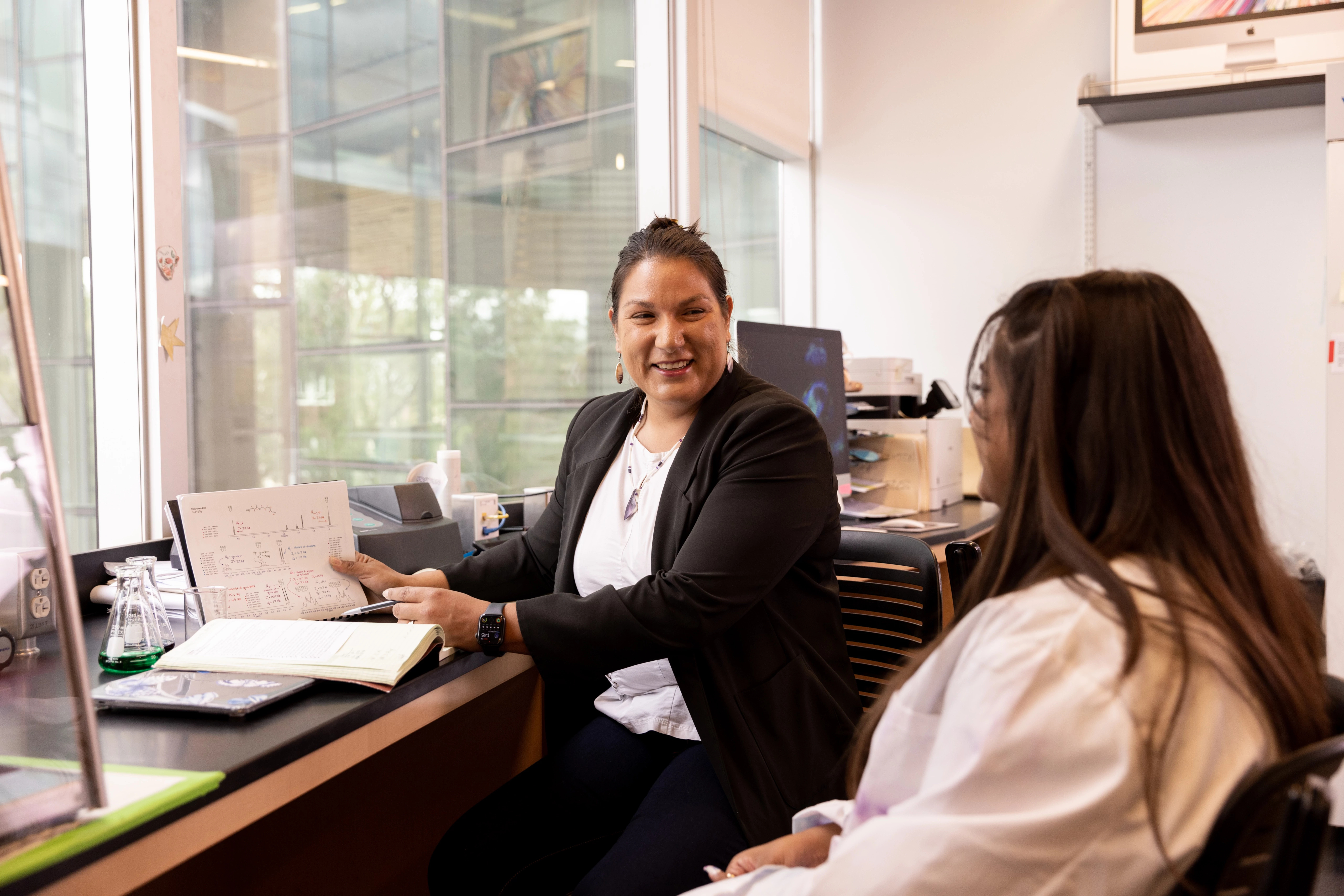 Faculty speaking to a student.