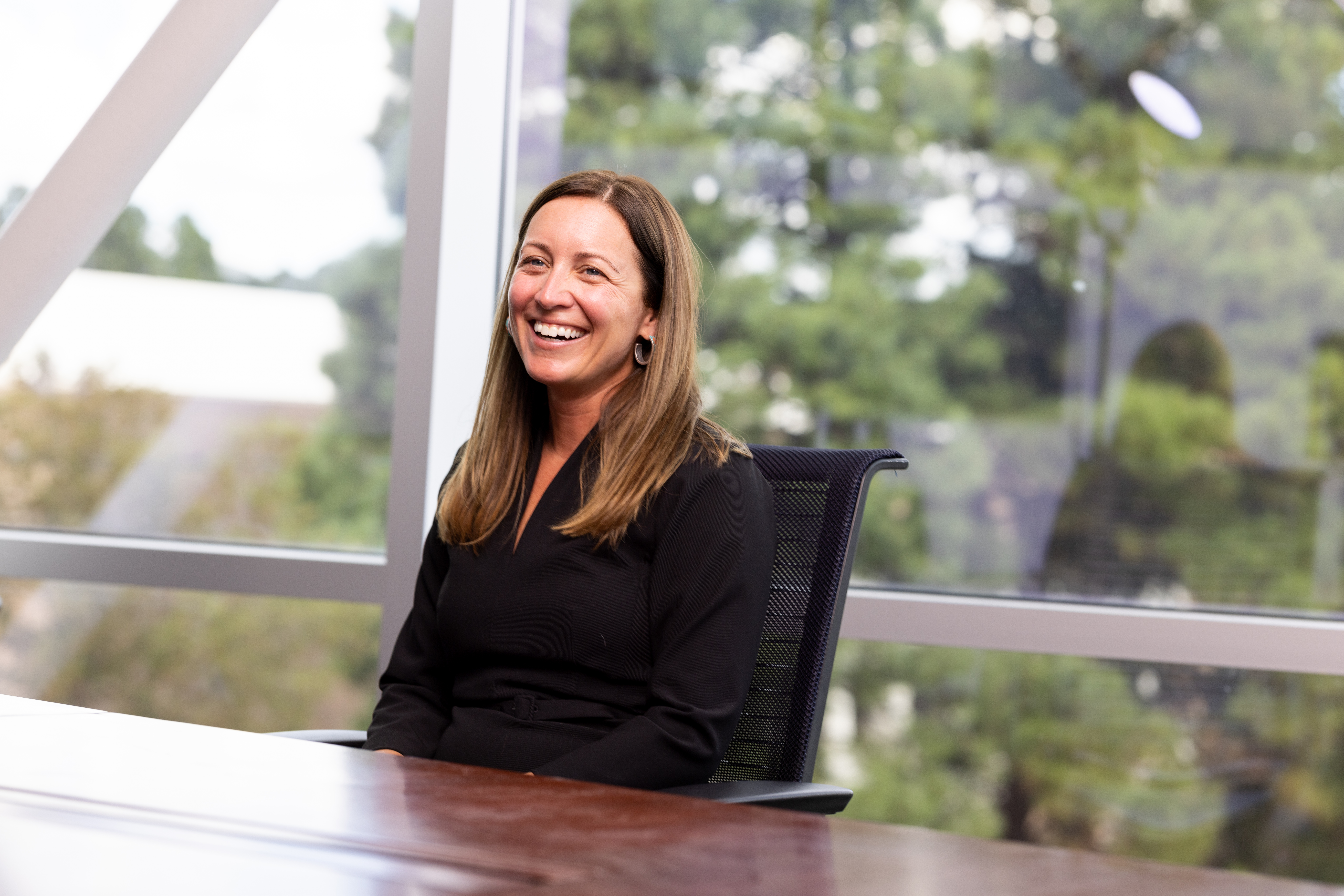 Faculty smiling in a meeting.
