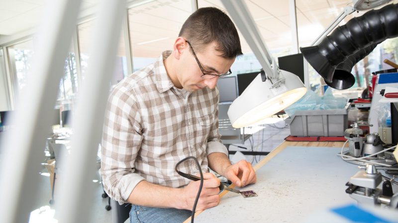 A person working on a microchip.