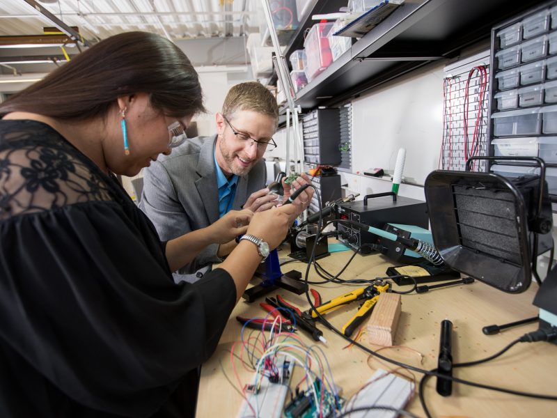 A professor and student working together on a project.