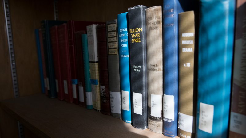 Northern Arizona University books on a shelf.
