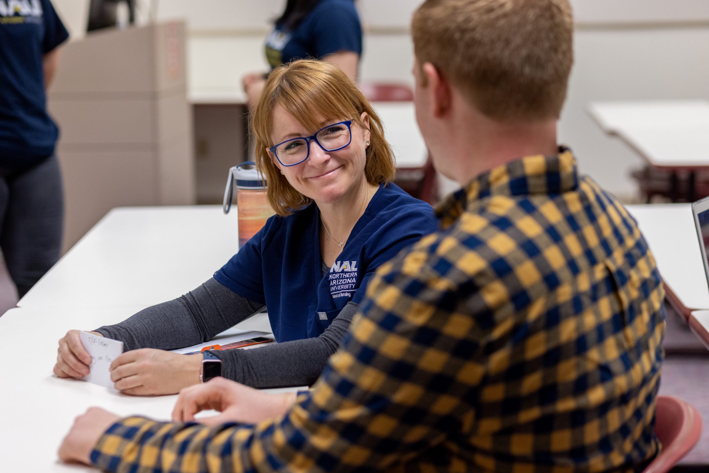 Two students sitting at a table together.