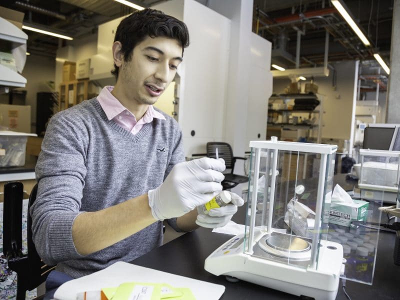 Joseph Espinoza labeling water samples in the lab