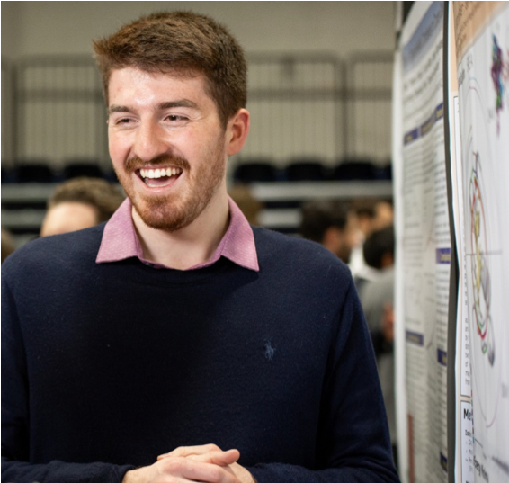 Kyle Ghaby in front of his research poster at the Undergraduate Symposium