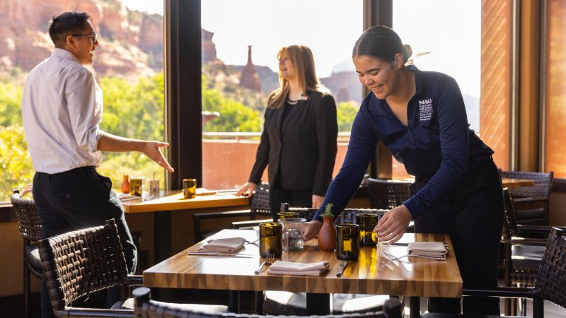 Students setting up a dining table.