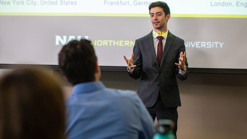 Student presenting in front of a classroom.