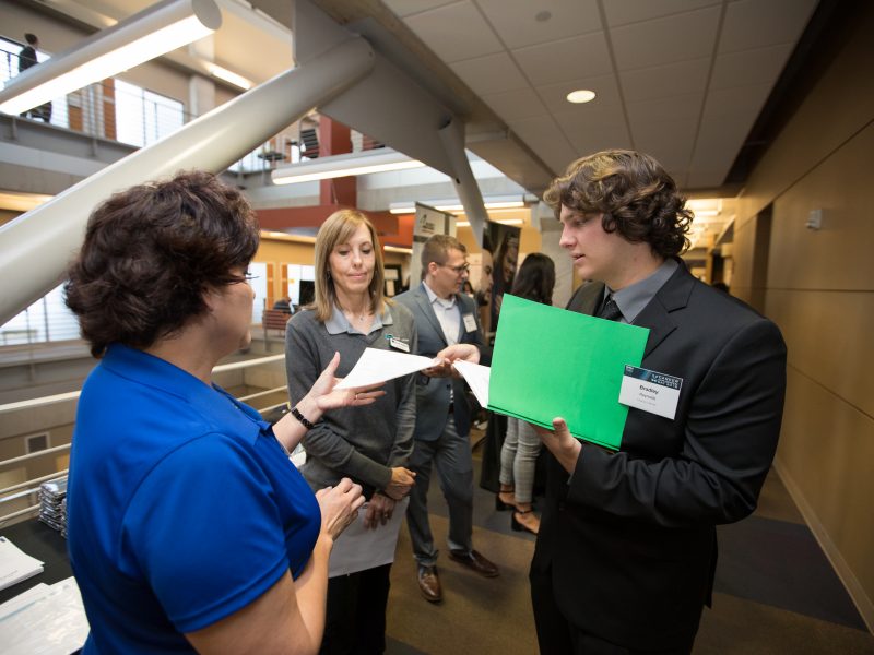Students and employers participating in a career fair.