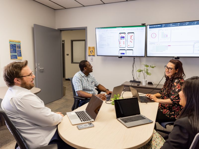 Faculty collaborating in a conference room.