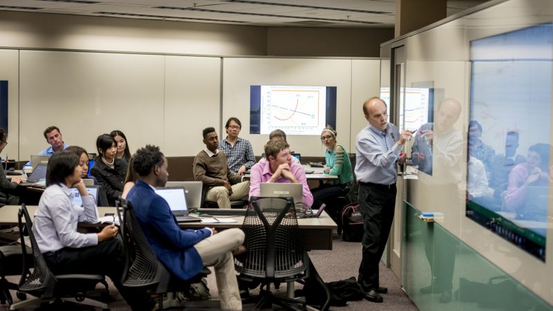 Students listening to their professor inside a business class in The W A Franke building.