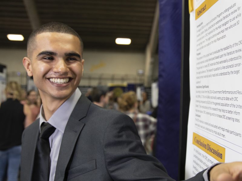 N A U student leads a presentation at the symposium.