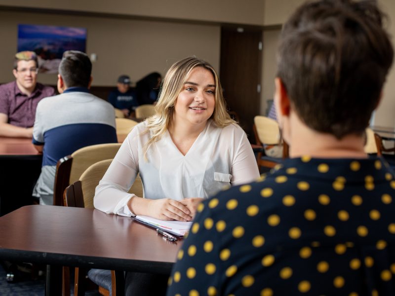 N A U alumni networking at an event.