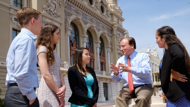 Professor telling study-abroad students about Monaco.
